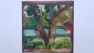 Satsanga retreat Goa India needle felted picture of the pool area bright blue water , deep lush green foliage of tropical trees, painting in wool