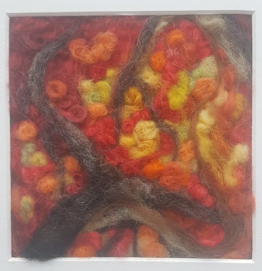 autumn trees needle felted picture, red and golden canopy of leaves in wool, brown wool defines the tree branches, in local woodland.
