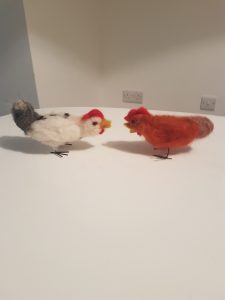 Felted white chicken and red, brown chicken.