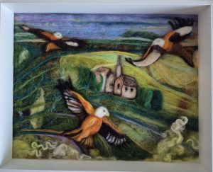 red kites over Amberley, Stroud. needle felted birds in green lush landscape, textural rolling hills, dark greens lime green fields with bright orange wings of the red kite birds flying soaring above Amberley fields.