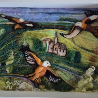 red kites over Amberley, Stroud. needle felted birds in green lush landscape, textural rolling hills, dark greens lime green fields with bright orange wings of the red kite birds flying soaring above Amberley fields.