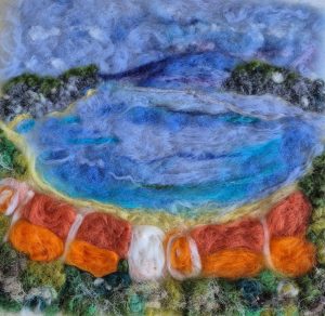 Felted beach scene, sea blues, terracotta buildings